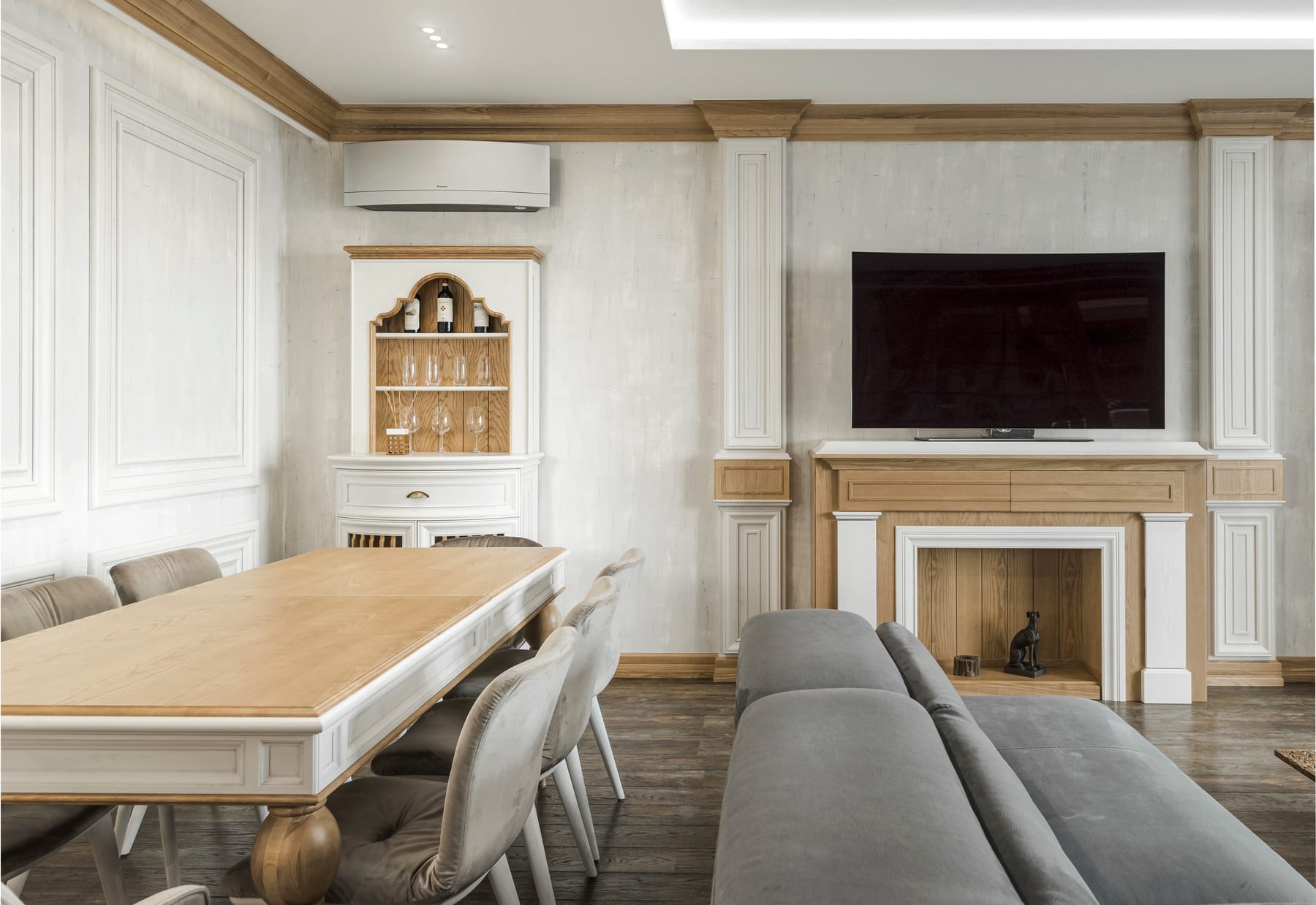 Living room and dining interior design with oak wall panelling, fireplace surround and cornice
