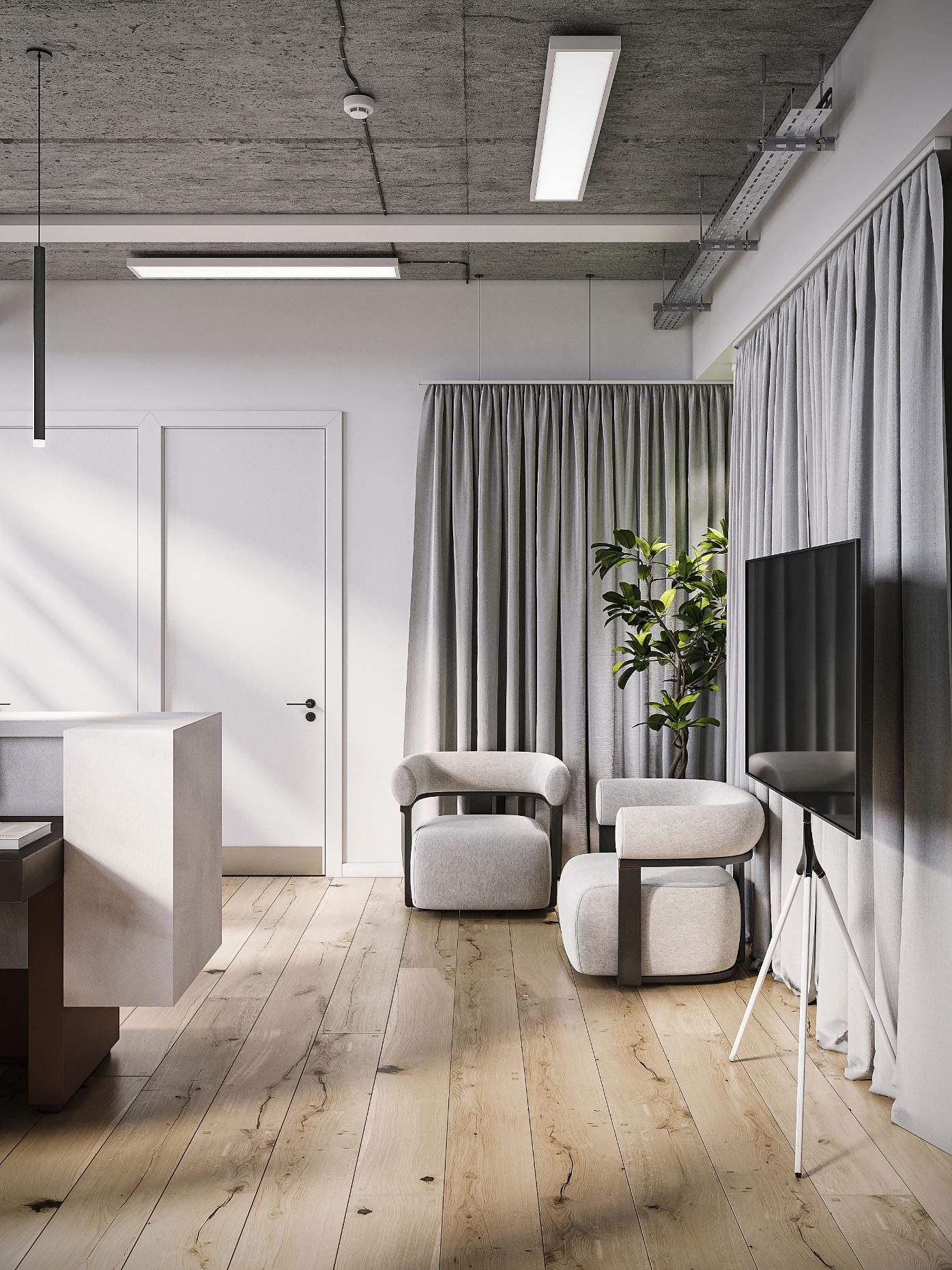 Informal meeting area with rounded boucle armchairs and presentation screen