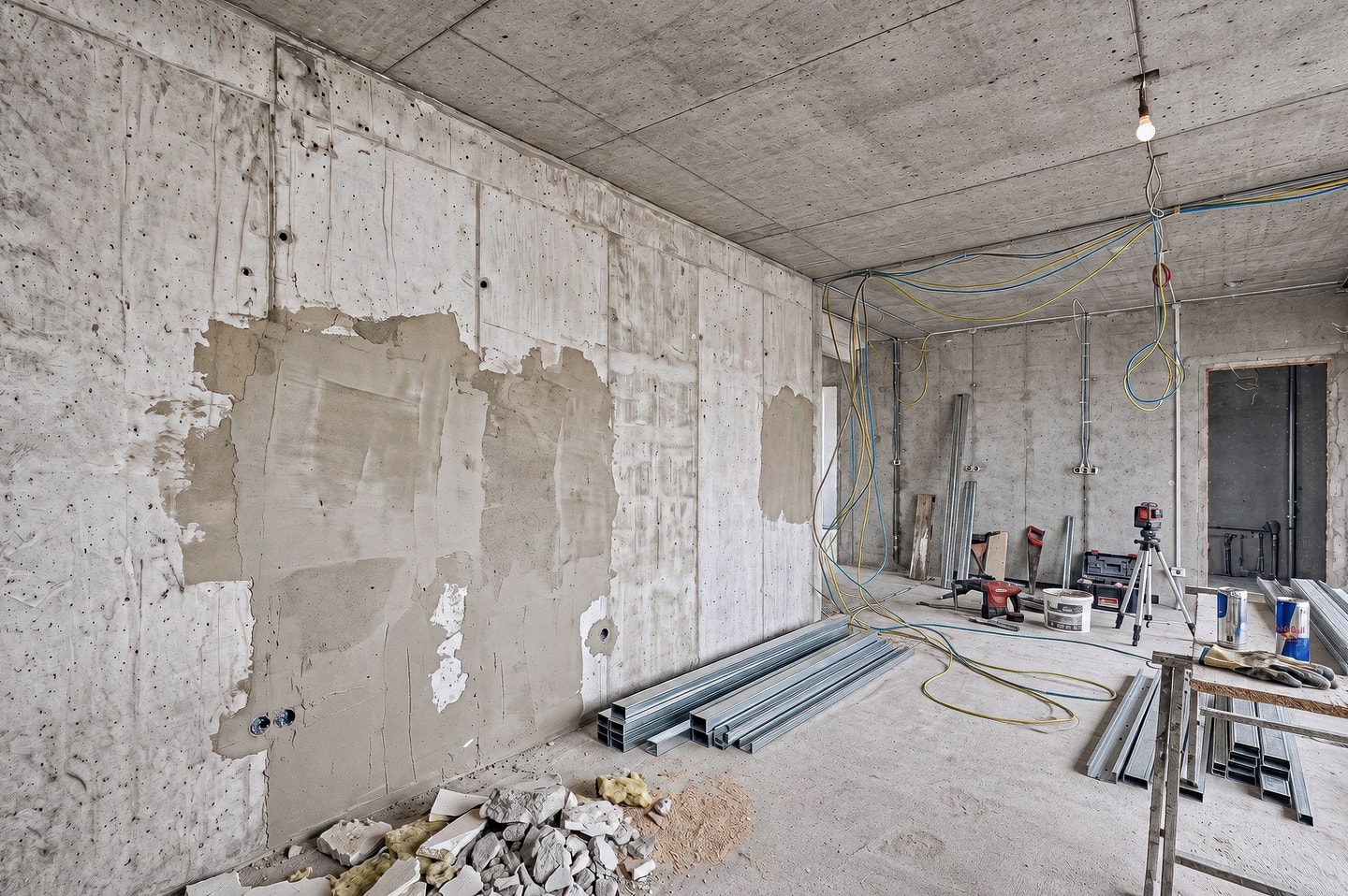 The F_OC kitchen before the renovation: the bare concrete shell stage with exposed wiring