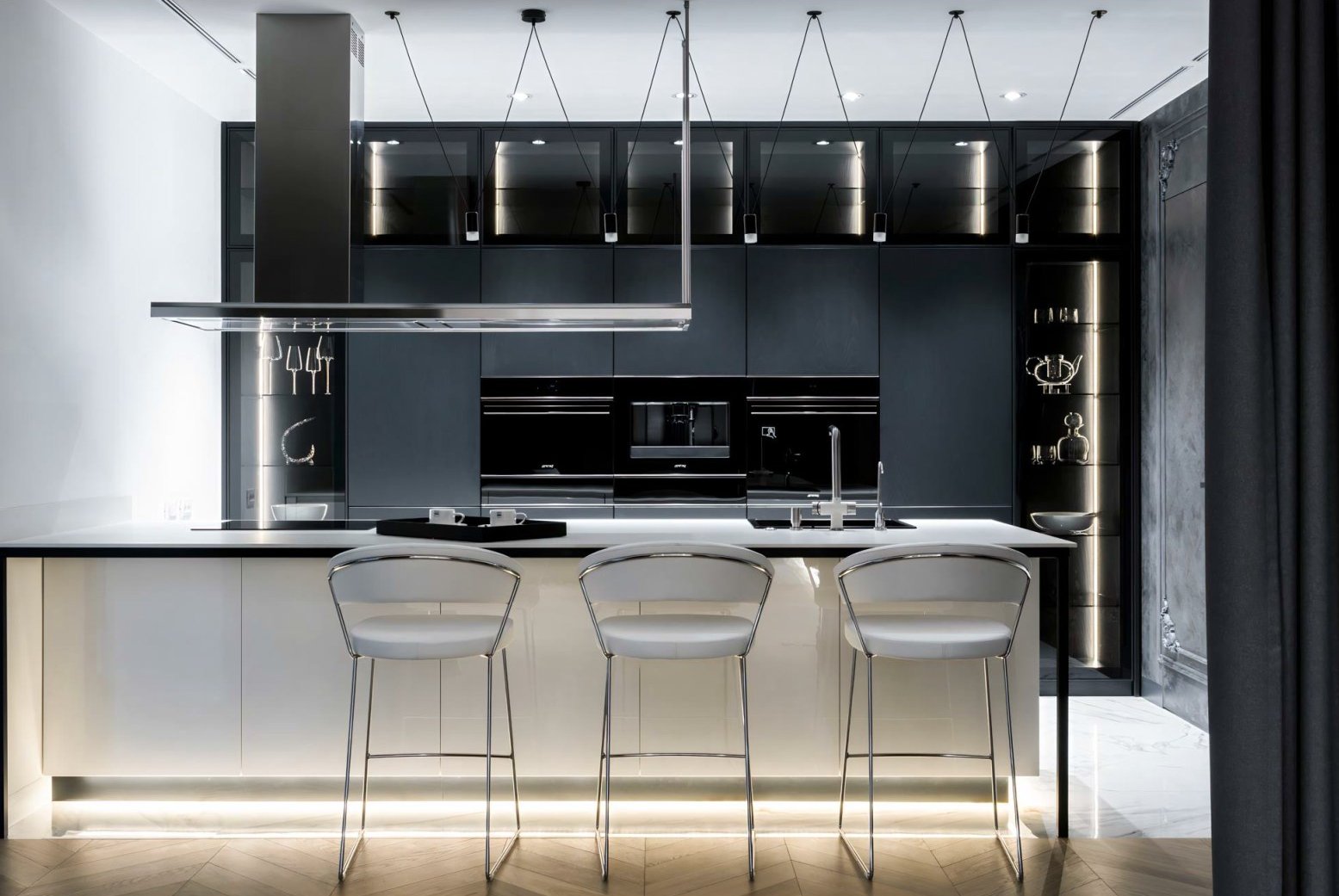 Bespoke kitchen interior design – matte black cabinetry, white island and pale oak floor